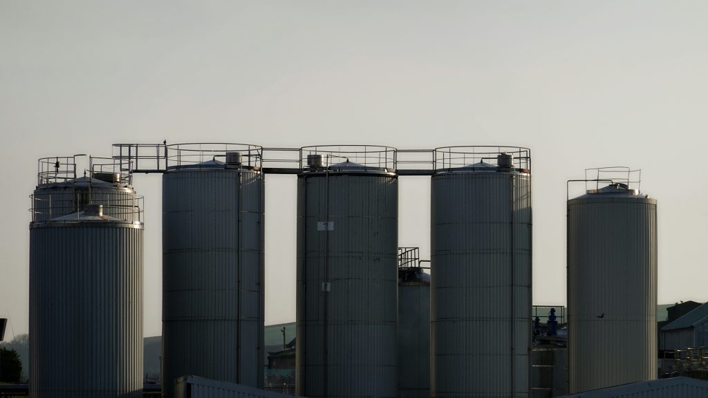 Industrial silos against a pale sky