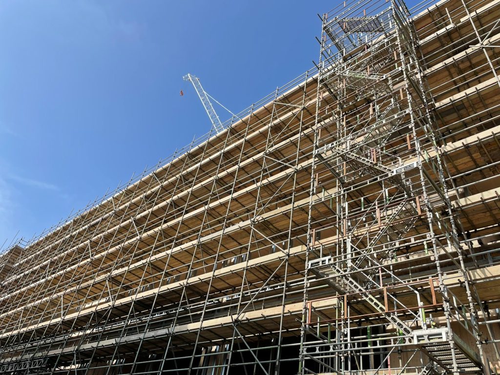 Scaffolding with a stair tower along the facade of a building under construction