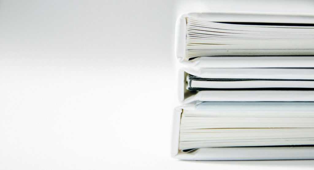 Stack of paper folders on a desk