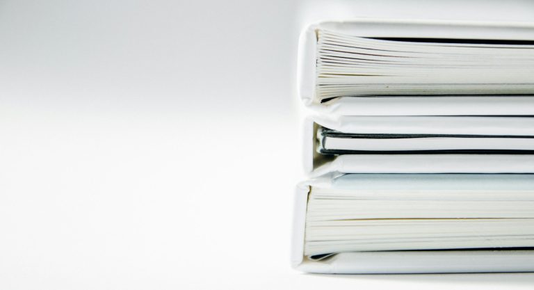 Stack of paper folders on a desk