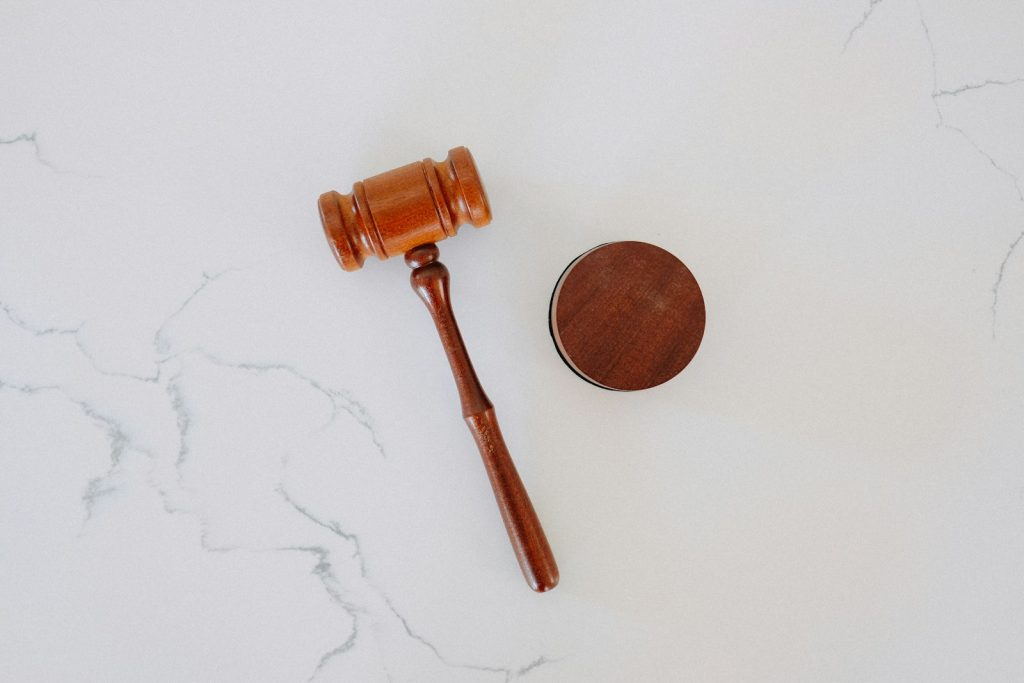 Office desk with law books, paper documents and a gavel symbol of legislation, neutral, no people