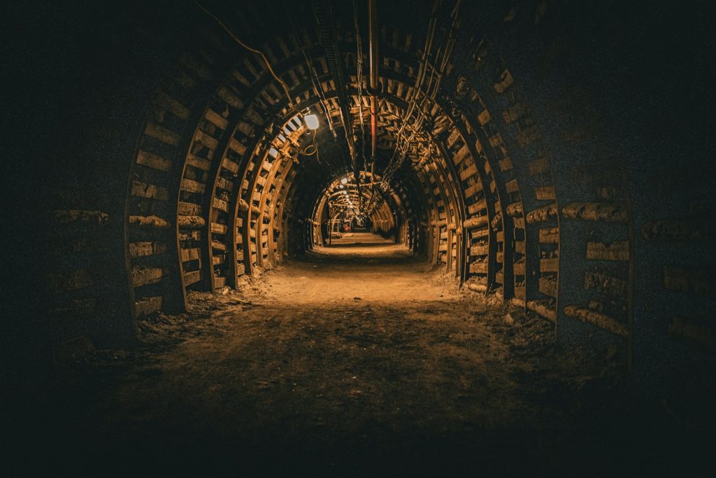 Empty, lit corridor in an underground coal mine with a supported roof
