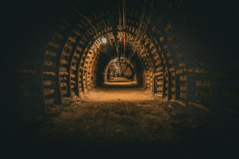 Empty, lit corridor in an underground coal mine with a supported roof