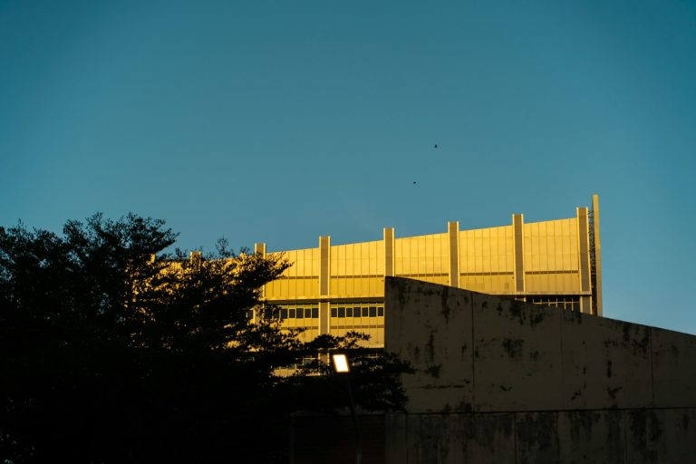 Facade of a modern government building against a blue sky