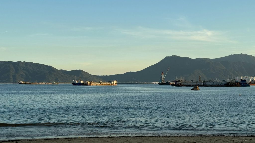 Ships on the water with mountains in the background