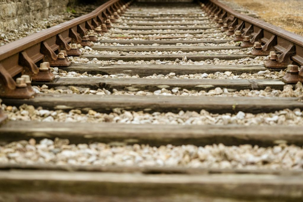 Railway tracks seen from a low angle, stretching into the distance
