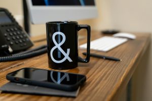Calm office desk with a coffee mug, symbolising work stress and mental strain in the workplace