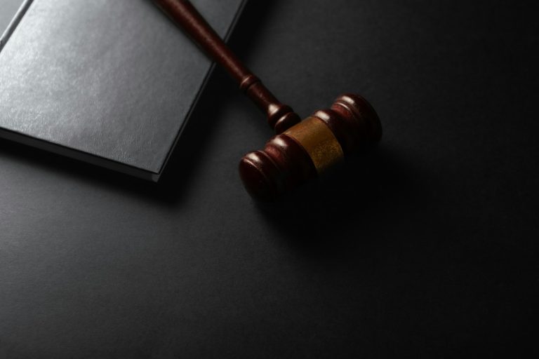 Judge's gavel on a law book, symbolising a legal investigation